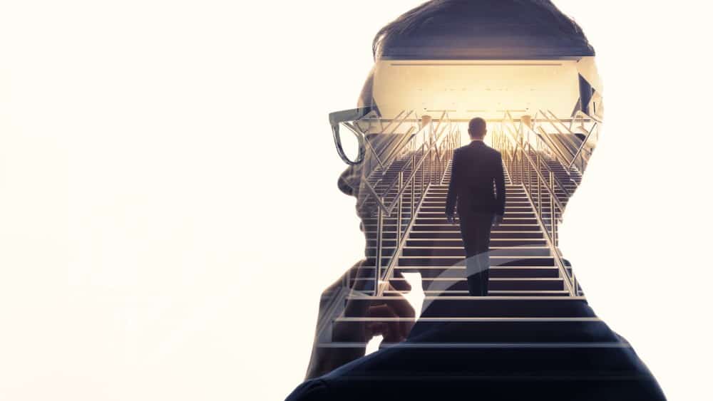 Double exposure of a businessman and stairs - Business Success Concept